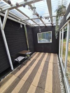 a patio with a pergola and a table and a bench at Ryysyranta 