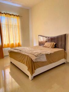 a bedroom with a large bed in a room at OYO The Sigma Star in Greater Noida