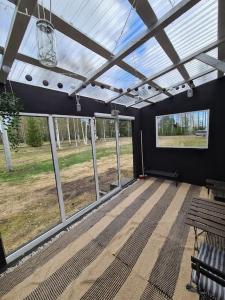 a screened in porch with a bench and windows at Ryysyranta 