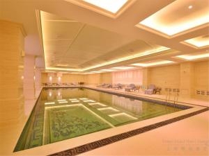 a large swimming pool in a hotel lobby at Urban Island Hotel Shanghai in Jiading