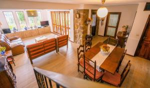 a dining room and living room with a table and chairs at Leiras de Candoz Douro Valley in Marco de Canaveses
