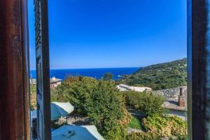 a view of the ocean from a building at Villa Zina Agios Dimitrios in Agios Dimitrios