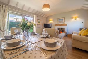 a living room with a table with plates and glasses at Sea Lodge in Brancaster