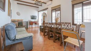 a living room with a table and chairs and a dining room at Casa Leal La Puebla de Los Infantes by Ruralidays in La Puebla de los Infantes