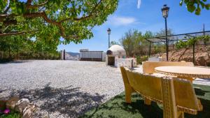 a park with a picnic table and a table and benches at Casa Los Bartolos Vélez Rubio by Ruralidays in Vélez Rubio