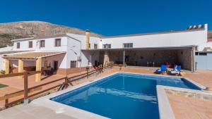 a villa with a swimming pool and a house at La Antigua Fábrica Teba by Ruralidays in Teba