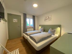 a bedroom with a bed and a window at Bike Lodge Spessart in Lohr am Main