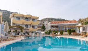 a large swimming pool in front of a hotel at Casa Blue Sarantis in Faliraki