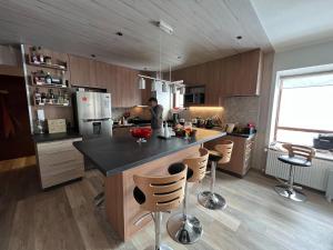 a kitchen with a island with bar stools at Departamento Valle Nevado Ski Resort Chile Ski in - Ski out in Valle Nevado