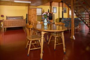 a wooden table and chairs in a living room at Bellview in Bellthorpe