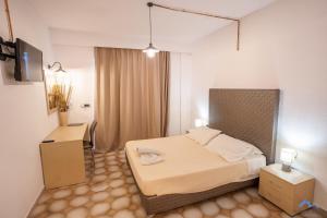a hotel room with a bed and a television at Casa Blue Sarantis in Faliraki +156 photos