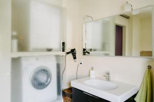 a bathroom with a sink and a mirror at Ferienhaus Ricki in Rust