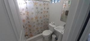 a white bathroom with a toilet and a sink at Cabrera 6 in Cabrera +16 photos