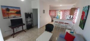a living room with a television and a dining room at Cabrera 6 in Cabrera
