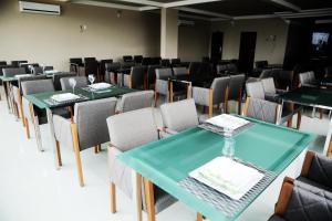 a dining room with green tables and chairs at Hotel Vale Do Xingu in Altamira +76 photos
