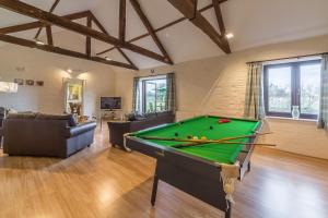 a living room with a pool table in it at Keepers Cottage in Fakenham