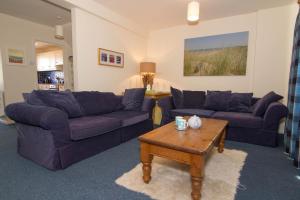 a living room with two couches and a coffee table at Sea Aster in Brancaster