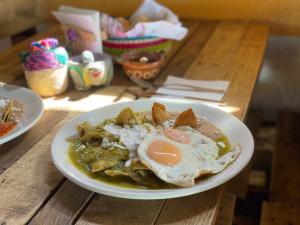 a plate of food with an egg on a table at Las Cabañas Mavoro in Jocotitlán