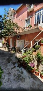 a house with potted plants in front of it at Hostel Lena-Mostar in Mostar