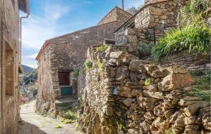 an old stone house with a stone wall at 2 Bedroom Amazing Home In Olargues in Olargues