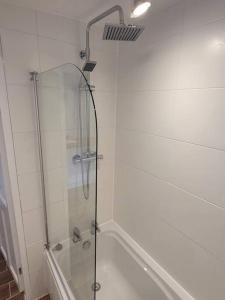 a shower with a glass door in a bathroom at Charming Liverpool Home in Liverpool