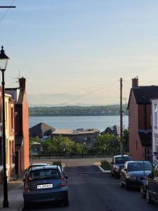 a street with cars parked on the side of the road at Charming Liverpool Home in Liverpool