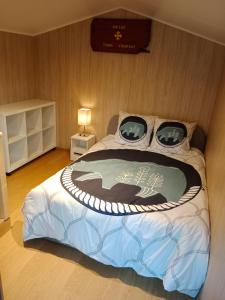 a bedroom with a large bed with a sign on the wall at les gites axéens (l'Ours) in Ax-les-Thermes
