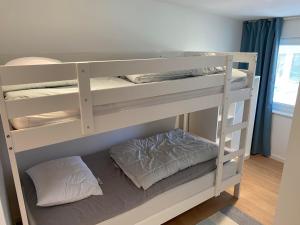 a bunk bed with two pillows on the bottom bunk at Casa Blanca in Strandbaden