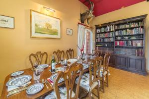 a dining room with a long table and chairs at Grooms Cottage C in Grimston
