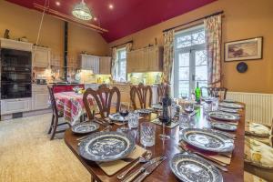 a dining room with a table with plates and silverware at Grooms Cottage C in Grimston