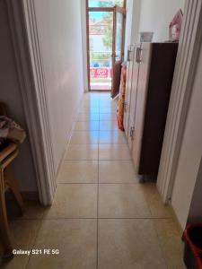 a hallway with a tiled floor with a door backdoor at Salda gölü in Yeşilova