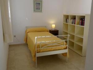 a small bedroom with a bed and a book shelf at GOLF Y PLAYA EN SAN JUAN in Alicante