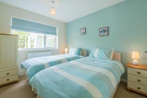 sypialnia z 2 łóżkami i oknem w obiekcie Sea Wind w mieście Brancaster