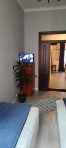 a bedroom with a bed and a flat screen tv at Lovely apartment on Dyrekcyjna street! In the very center of Katowice! in Katowice