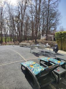 a group of picnic tables in a parking lot at Maison piscine chauffée in Puybegon