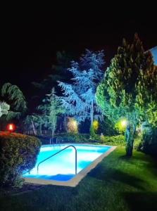 a swimming pool in a yard at night at HOSTAL LA SAVINA in Cervera