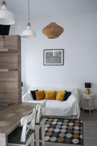 a white living room with a bed and a table at Dohány Street Delight in Budapest