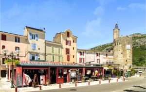 a street in a town with buildings and a castle at 2 Bedroom Lovely Apartment In Als in Alès