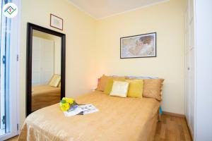 a bedroom with a bed and a mirror at Vedo il Mare by TuscanyWeGo in Livorno