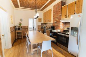 a kitchen with a wooden table and a brick wall at Bed and Breakfast du Village BBV in Montréal +25 photos