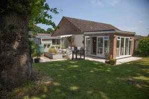 a house with a yard with a patio at Lodge End in Heacham