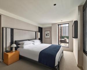 a hotel room with a bed and a balcony at Hotel AKA NoMad in New York