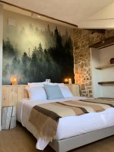 a bedroom with a large bed with a painting on the wall at Bed & Breakfast Perbos 1556 in Labastide-Clairence +89 photos
