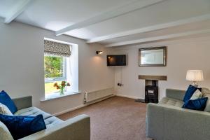 a living room with two couches and a window at Finest Retreats - Trethew Cottage in Carnbrea