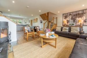 a living room with a couch and a table at Wigeon Cottage in Thornham