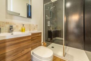 a bathroom with a shower and a toilet and a sink at Wigeon Cottage in Thornham +20 photos