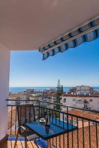 a blue table on a balcony with a view at ElBarrioCasablanca in Nerja