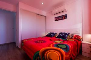 a bedroom with a bed with a red comforter at ElBarrioCasablanca in Nerja