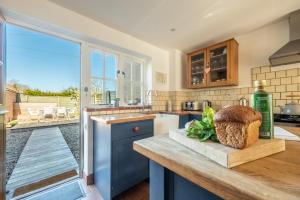 a kitchen with a view of a patio at Marigold Cottage in Docking