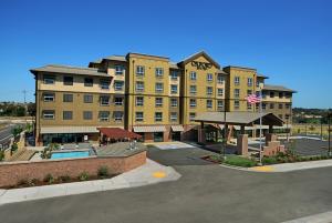a large hotel with a parking lot in front of it at Oxford Suites Paso Robles in Paso Robles